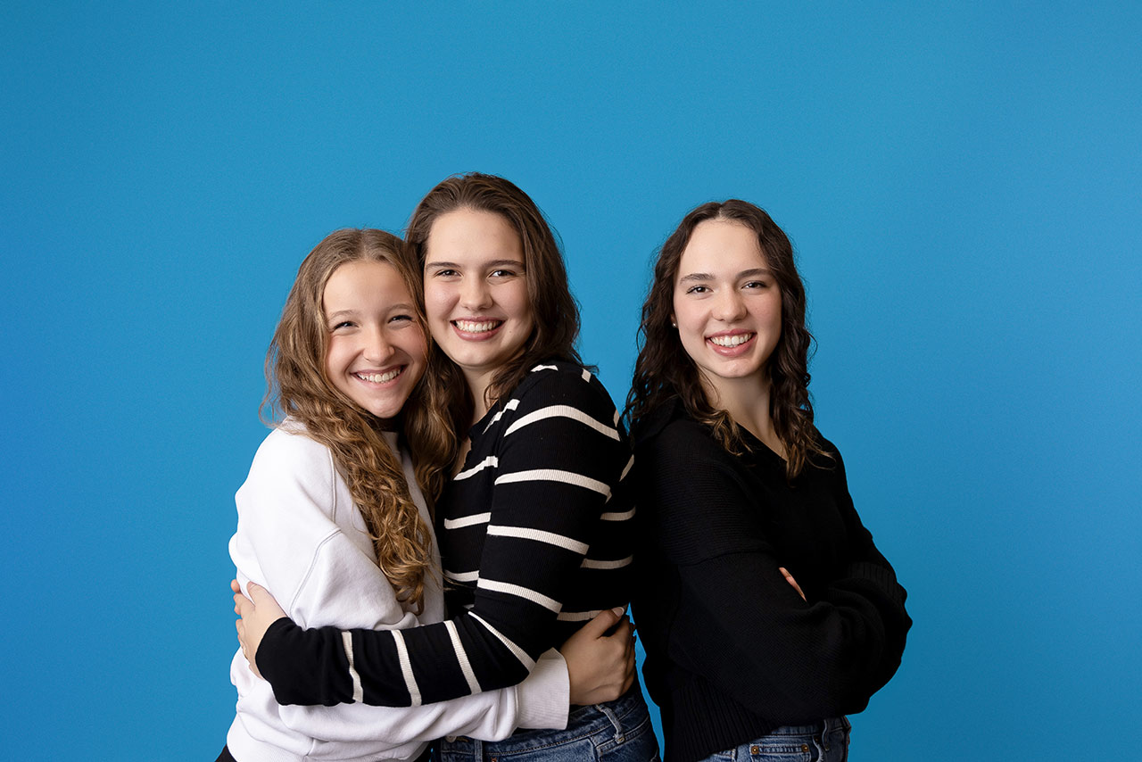 Group of friends smiling with their new braces in Madisonville.